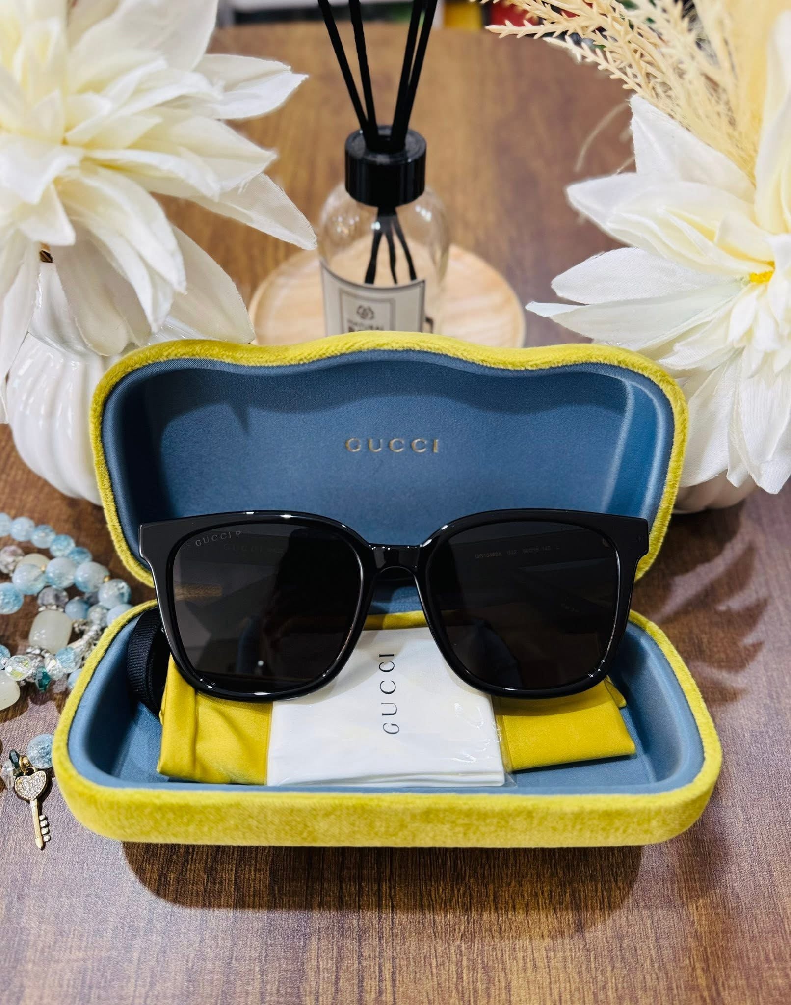 MAY Kaya Gucci black square sunglasses in yellow/blue case